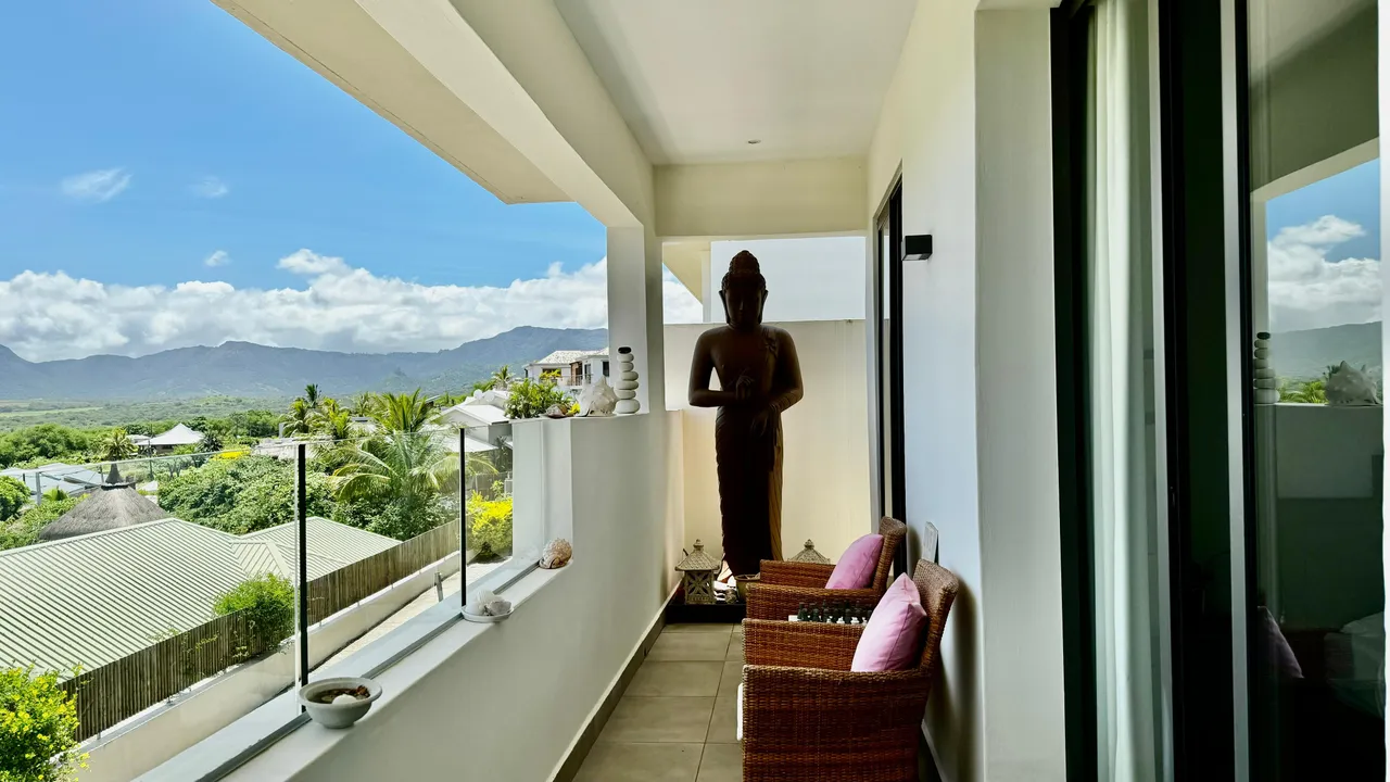 Terrasse avec mobilier d'extérieur et vue dégagée sur les montagnes. Éléments décoratifs en harmonie avec l'espace.
