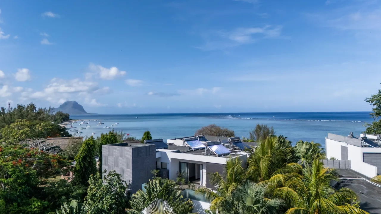 Vue dégagée sur l'océan depuis le penthouse, entouré de verdure.