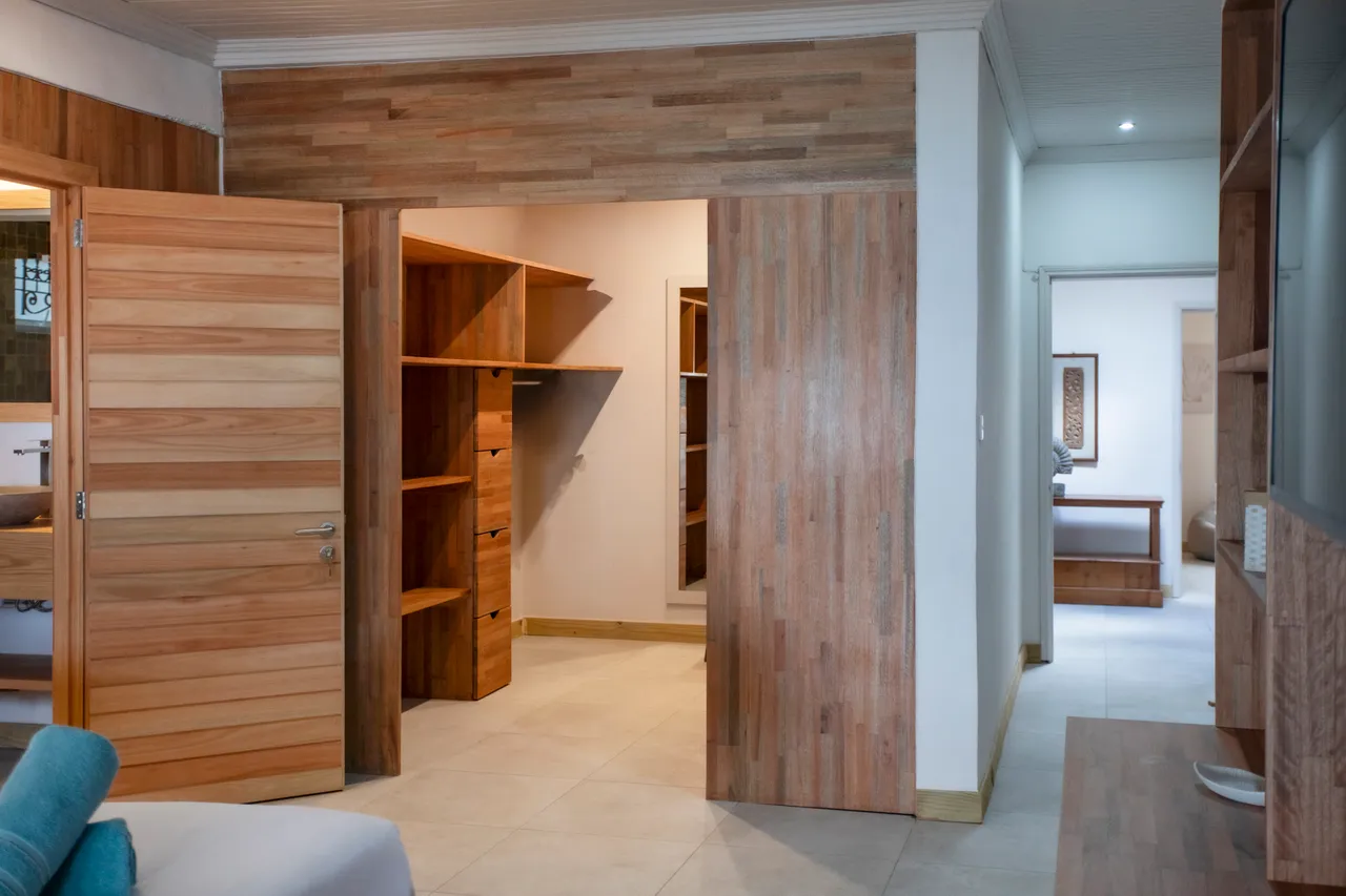 Bois clair des murs et des rangements intégrés dans l'espace. Dressing spacieux adjacent à la chambre. Accès direct à la salle de bain attenante.